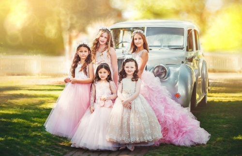 Toronto Fashion photographer catches flower girls on camera posing in front of the vintage car.